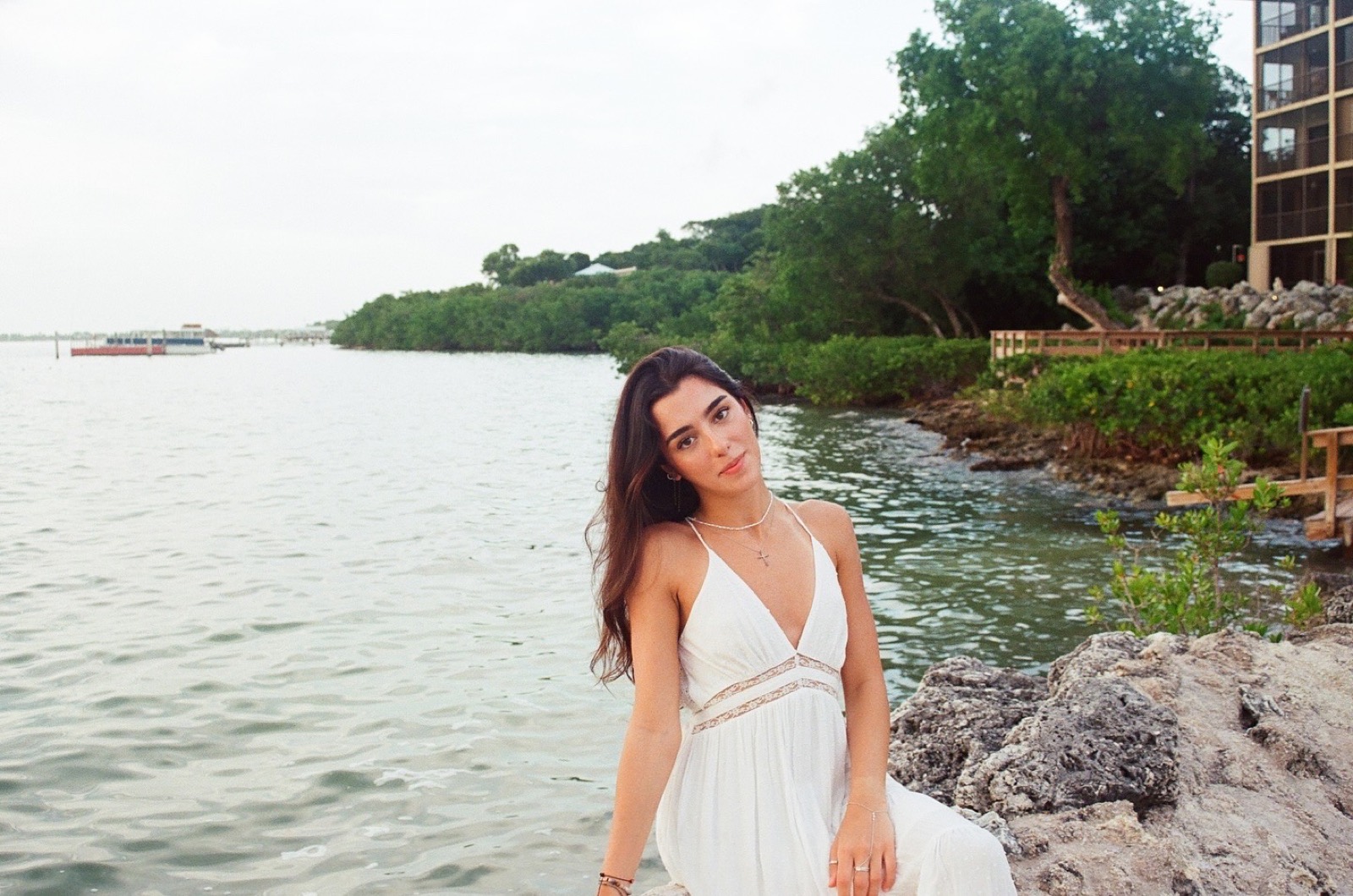 Mar by the water in a white dress